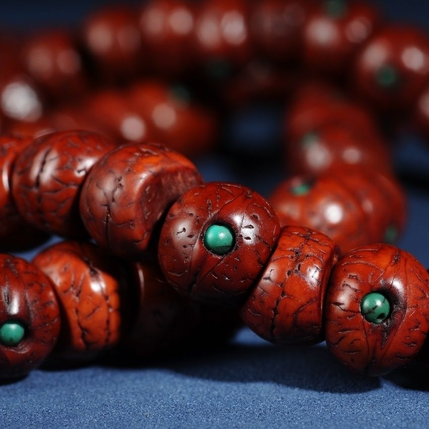 Close detail of red brown inlaid phoenix eye bodhi beads