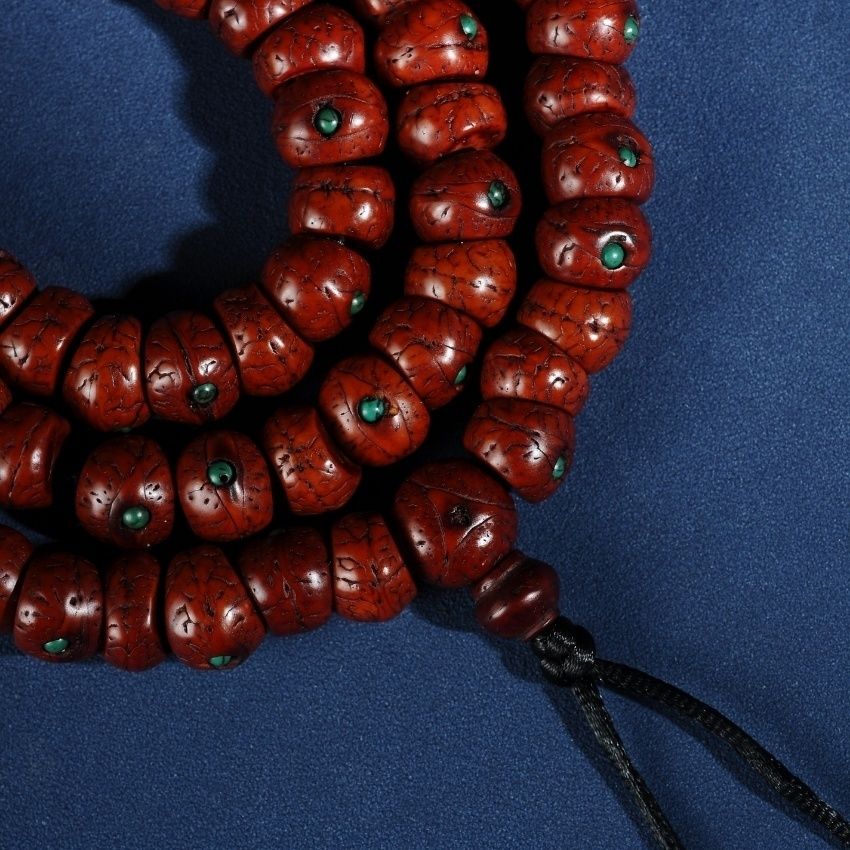 Cord and bead detail of 108 bead phoenix eye bodhi mala bracelet