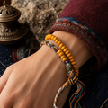 luckyallthing Tibetan amber double-wrap bracelet in a warm outdoor styled scene