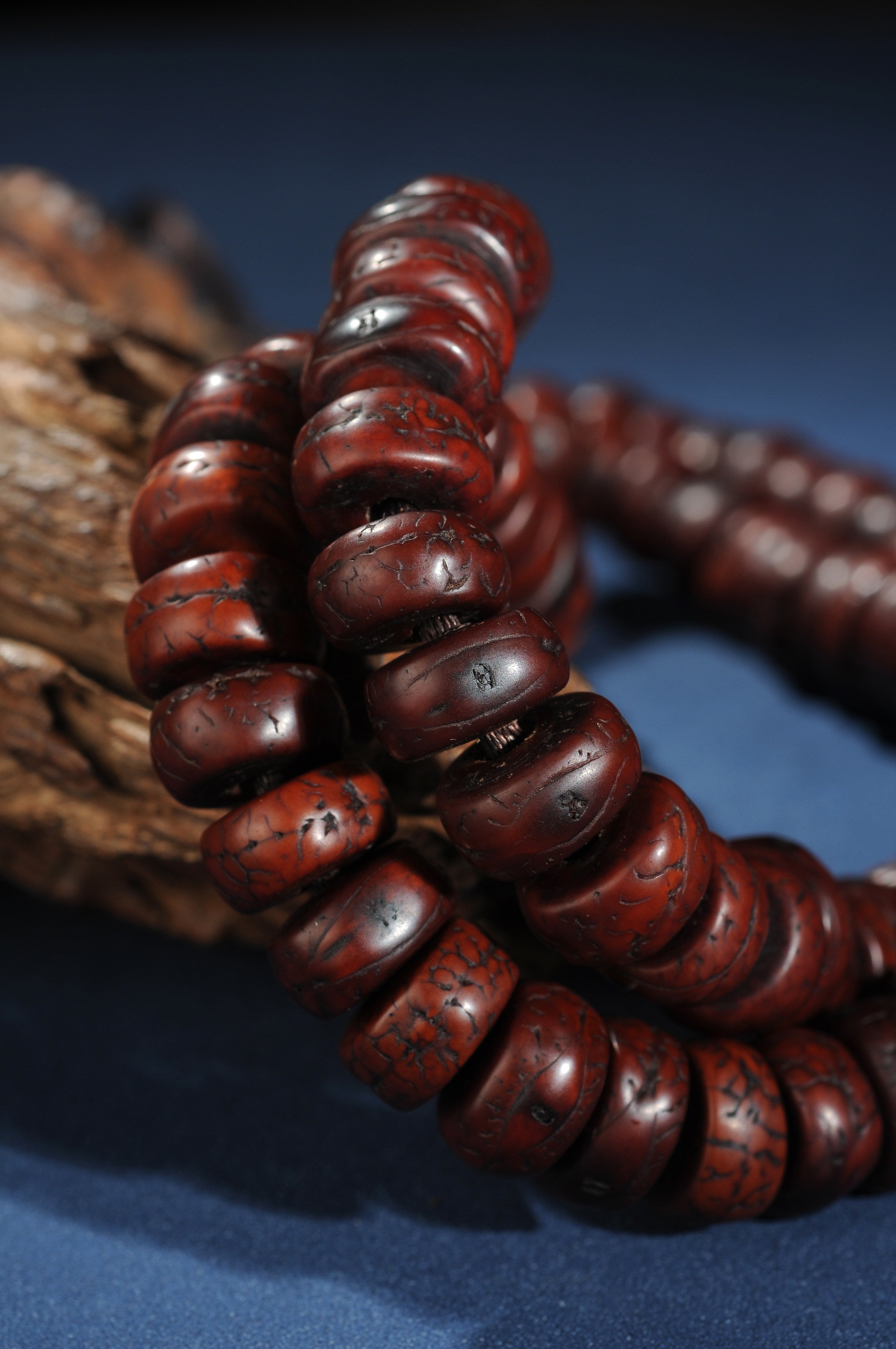 Sliced phoenix eye bodhi bead strand detail with aged red-brown tone
