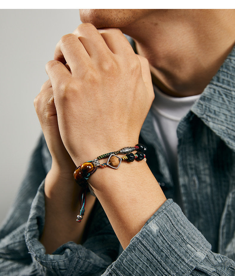 Anlan woven bracelet worn on wrist with tiger eye beads and braided cord