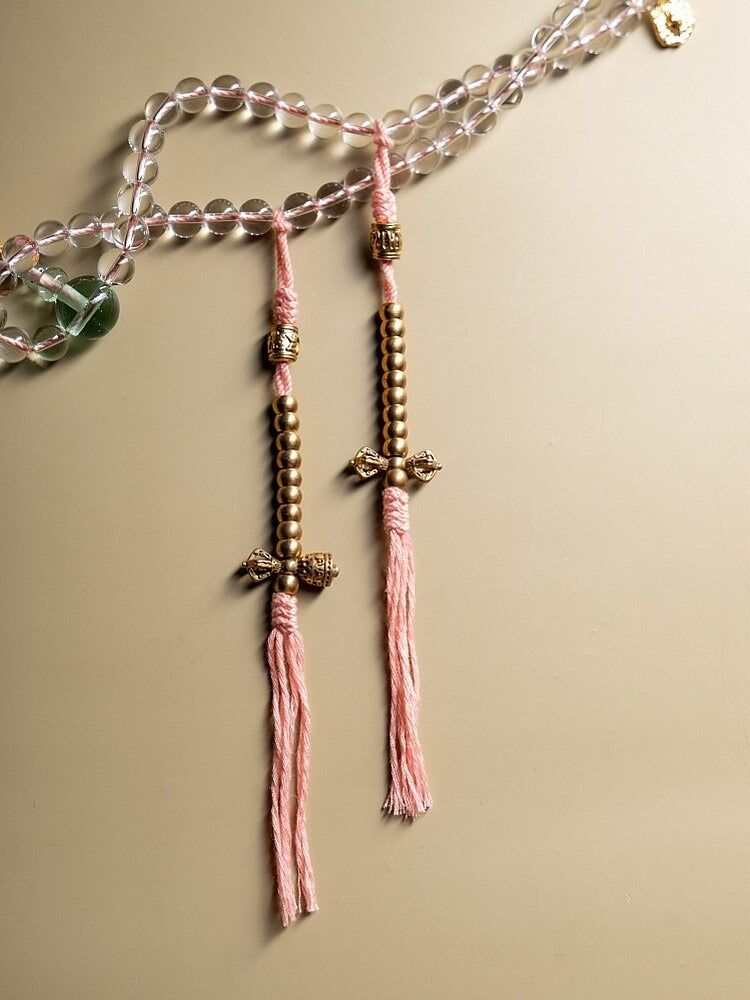 White crystal mala with pink tassels and warm metal counting accents