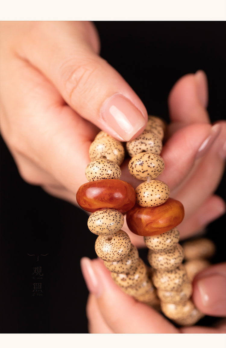 Close hand view of Xingyue bodhi bracelet and red accent bead