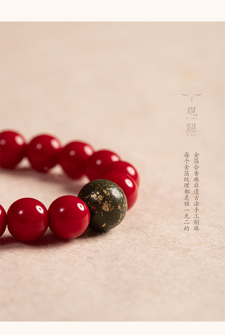 Close view of red glass beads and green gold foil incense bead
