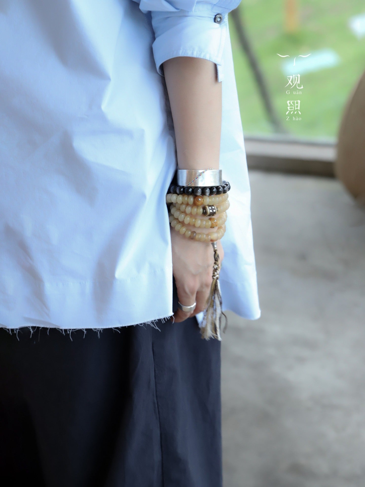 Daoge sheep horn mala styled on wrist with warm tassels