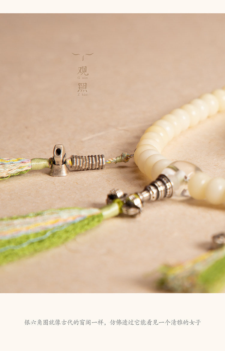 White bodhi mala with silver-tone counter-style detail and tassel