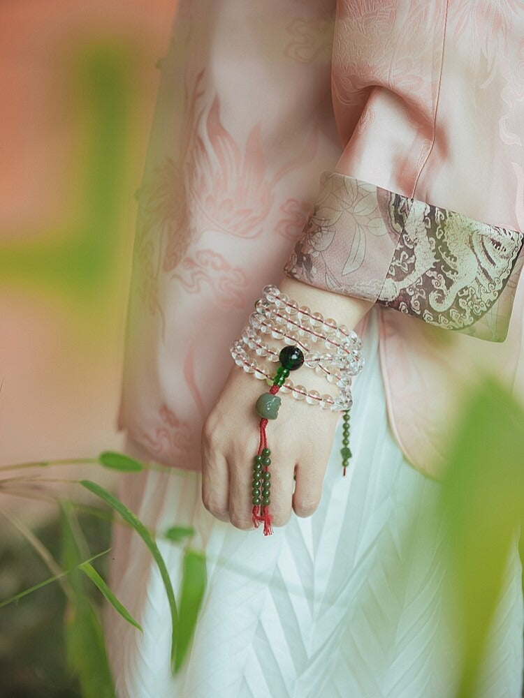 Tibetan-style white crystal mala held in hand
