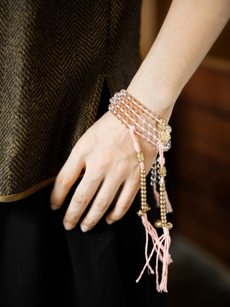 White crystal 108 mala wrapped around the wrist with pink tassels