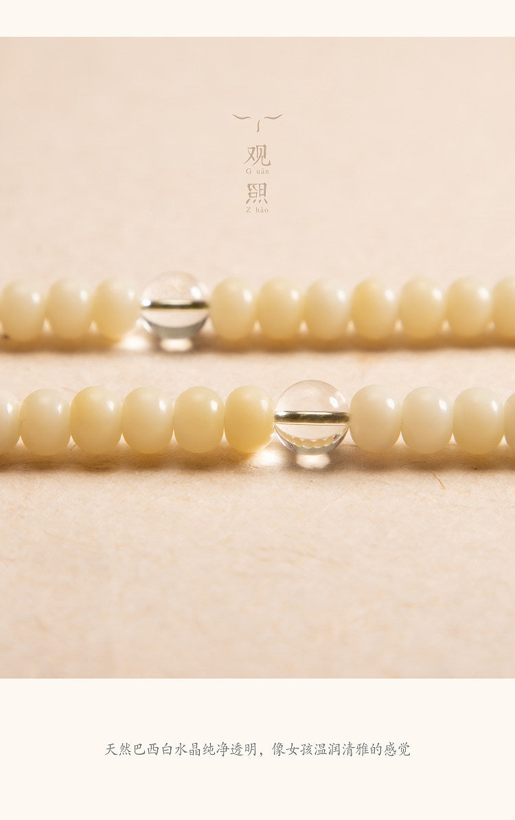 Close detail of white bodhi beads and clear white crystal waist bead