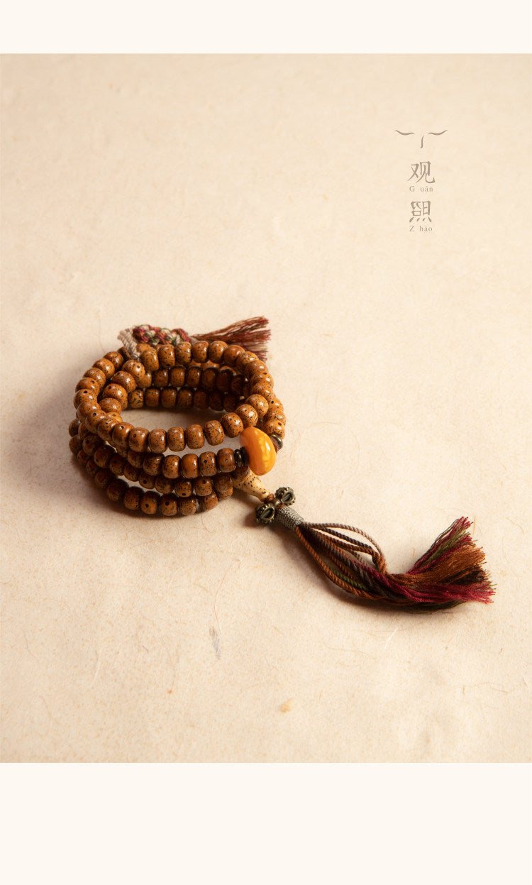 Coiled Xingyue bodhi 108 mala with multicolor tassel