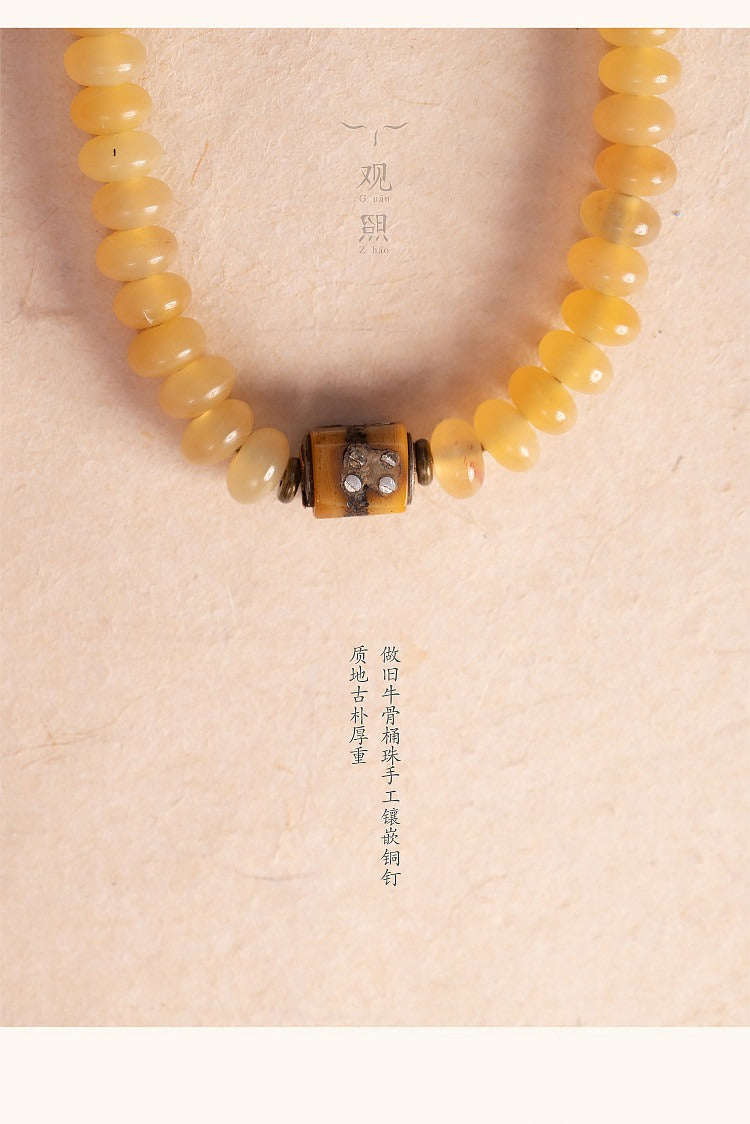 Detail of sheep horn mala beads with patterned accent bead