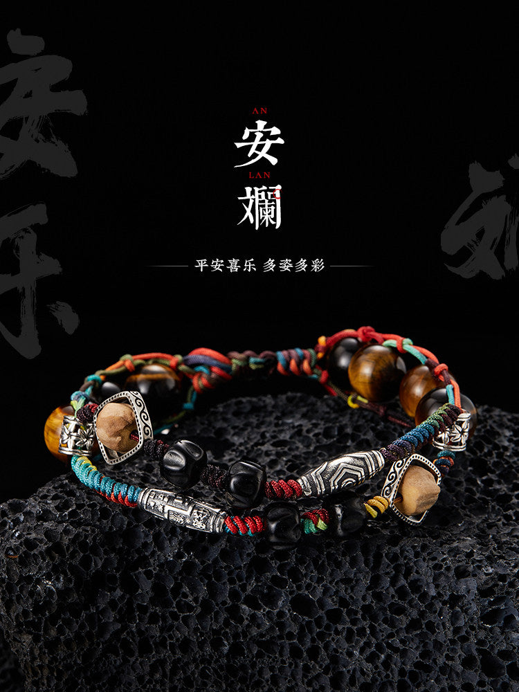 Anlan woven bracelet on black background with multicolor cordwork