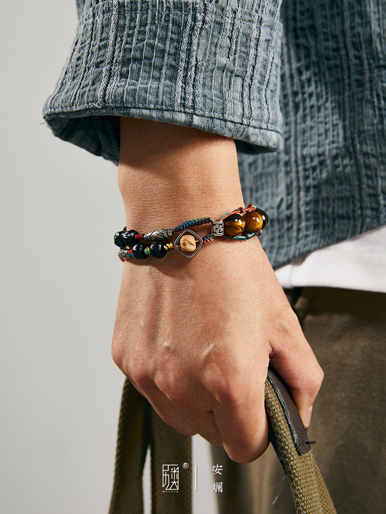 Woven bead bracelet shown on wrist with tiger eye bead accents