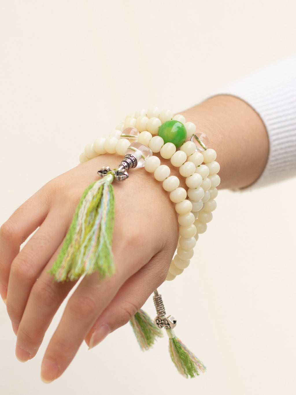 White bodhi 108 mala worn wrapped around the wrist