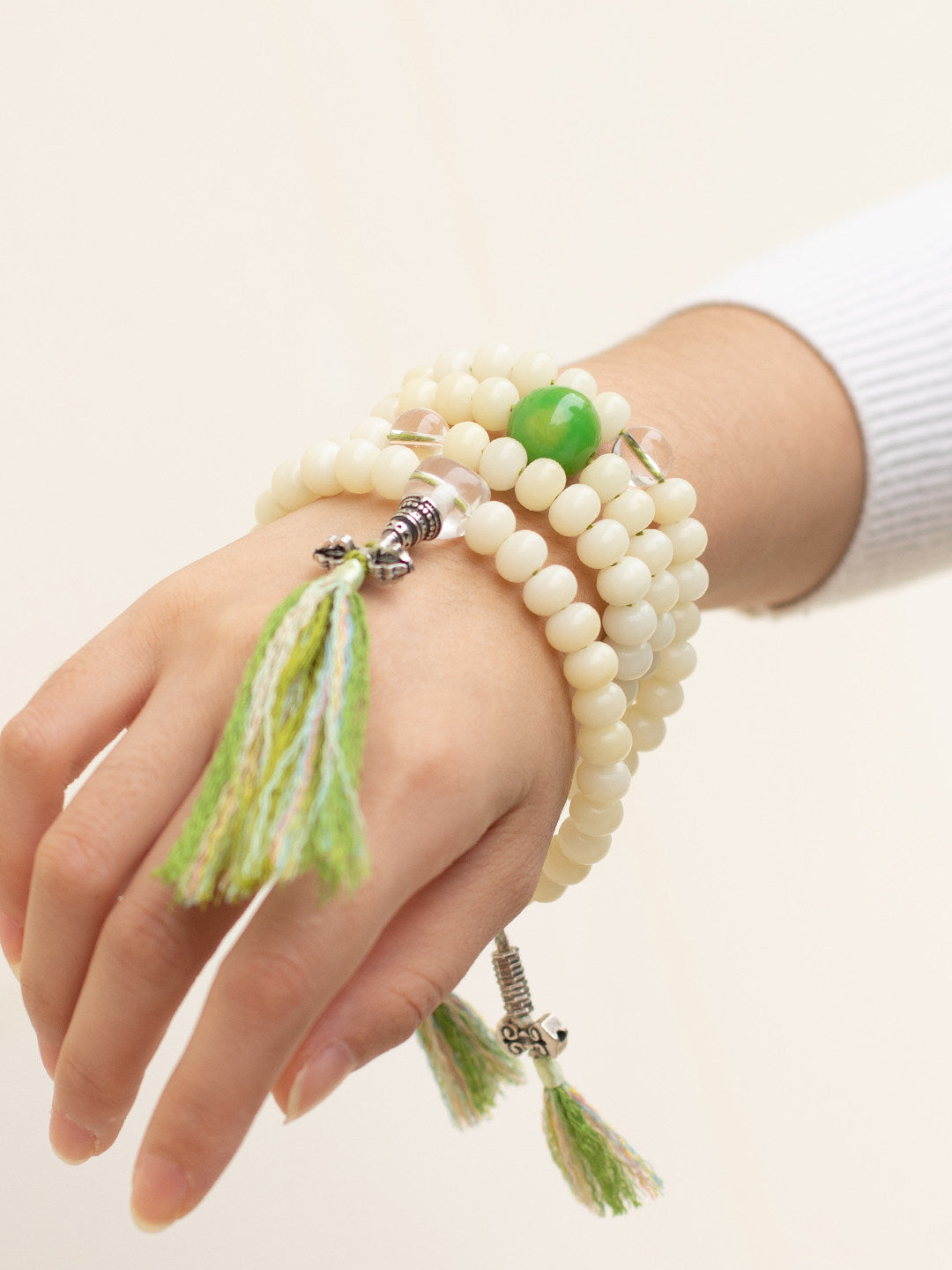 White bodhi 108 mala worn wrapped around the wrist