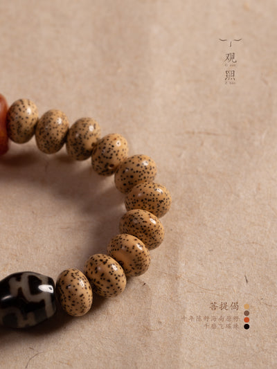 Close view of Xingyue bodhi bead bracelet with speckled seed beads