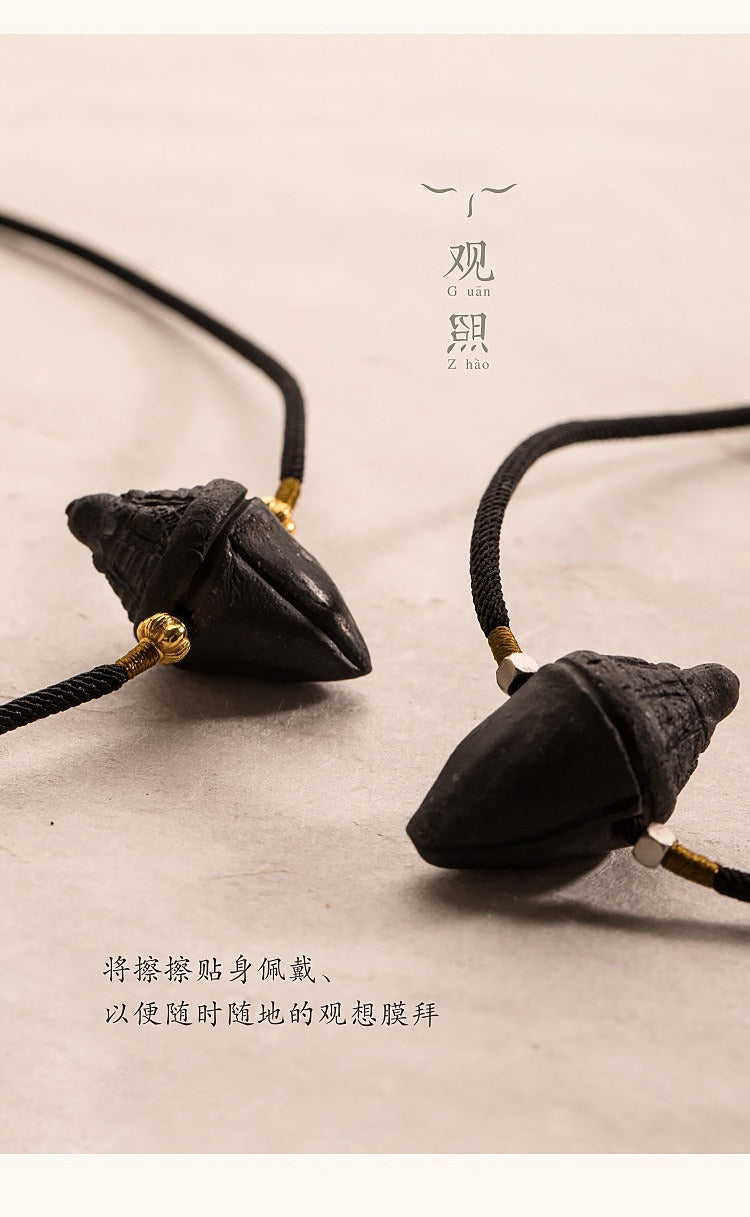 Two black ceramic-clay tsatsa pendant necklaces with braided cords