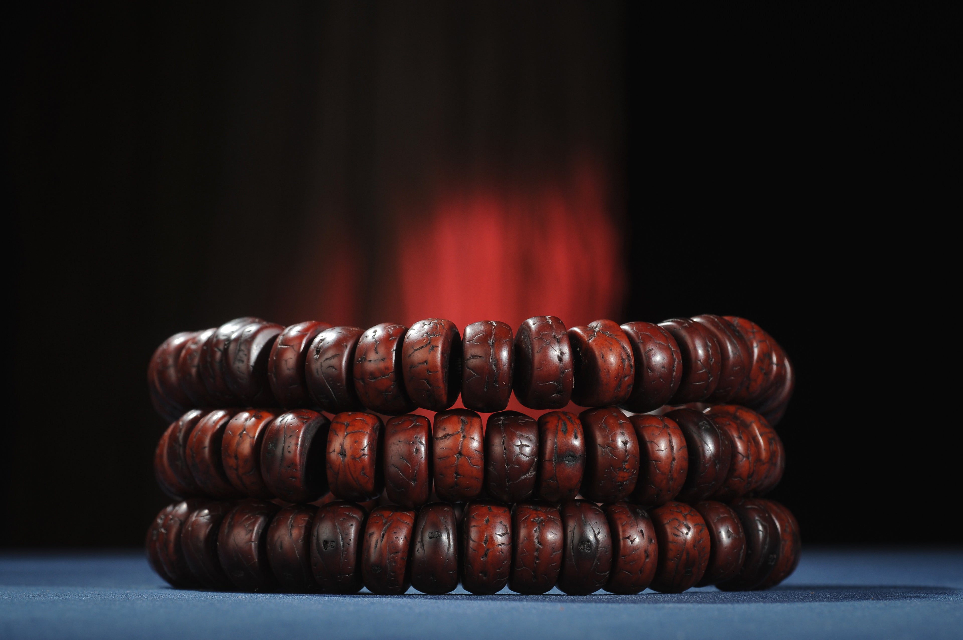 Stacked view of red-brown flattened phoenix eye bodhi beads